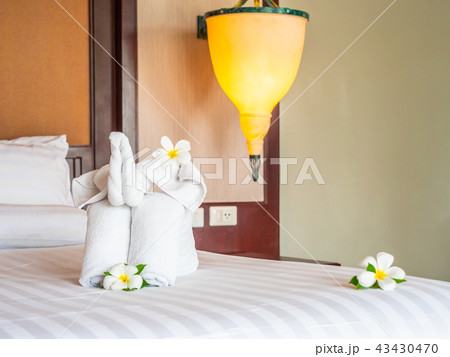 White elephant towel and comfortable pillow on bed White elephant towel and comfortable pillow on bed 43430470