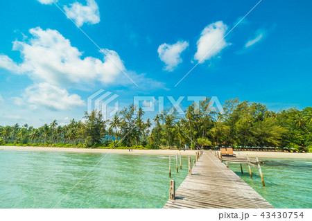 Wooden pier or bridge with tropical beach and sea in paradise island 43430754