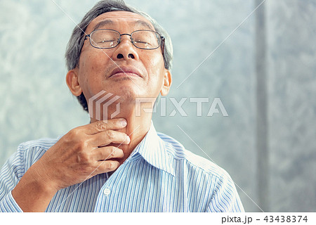 Senior man touching his neck and having pain Senior man touching his neck and having pain 43438374