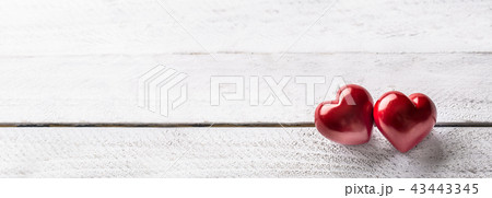 Two red valentines hearts on wooden table. Two red valentines hearts on wooden table. 43443345