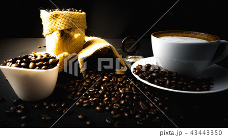 A cup of coffee on a black table A cup of coffee on a black table 43443350