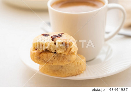 A cup of coffee with homemade cookies on a white background. A cup of coffee with homemade cookies on a white background. 43444987