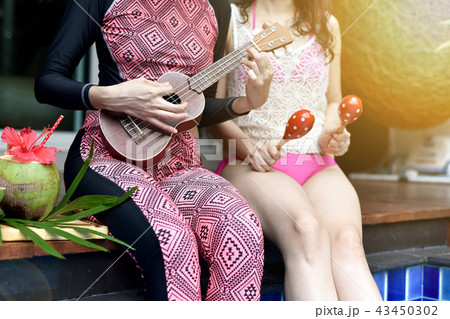 Pool party, Happy women enjoy playing music. 43450302