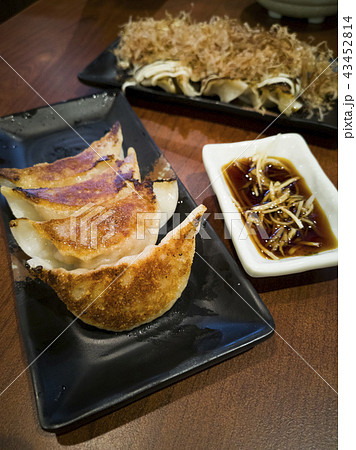 Two plates of gyoza dumplings serving hot. 43452814