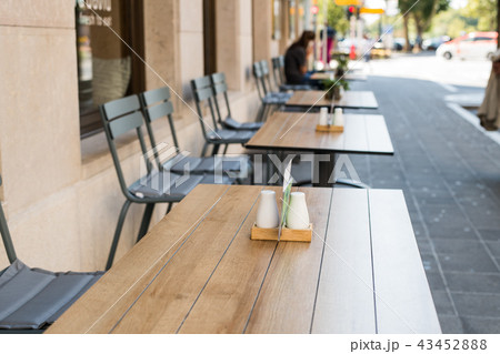 Typical summer outdoor cafe. Tables and chairs summer cafe, restaurant on streets of city in Typical summer outdoor cafe. Tables and chairs summer cafe, restaurant on streets of city in 43452888