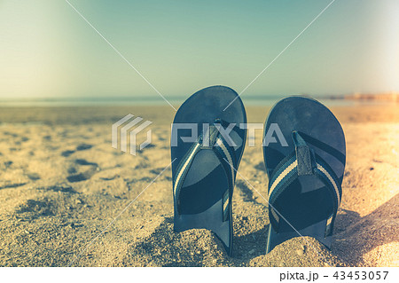 sandal flip flop on yellow sand Summer fun time sandal flip flop on yellow sand Summer fun time 43453057