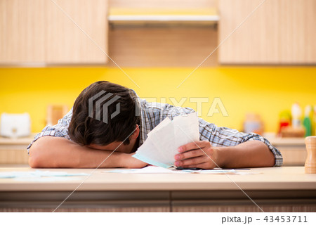 Young man husband in budget planning concept Young man husband in budget planning concept 43453711