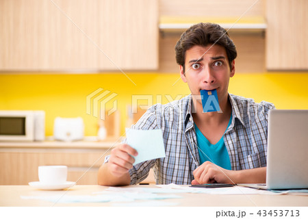 Young man husband in budget planning concept Young man husband in budget planning concept 43453713