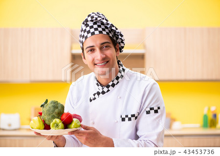 Young professional cook preparing salad at home 43453736