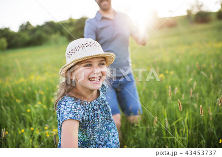 Father with a small daughter running in spring nature. 43453737