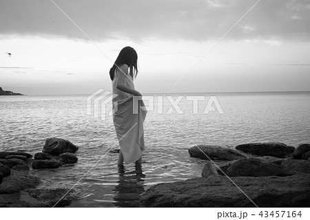 nice romantic girl in a blue dress against the sea nice romantic girl in a blue dress against the sea 43457164