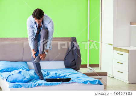 Employee in the bedroom being late for his job Employee in the bedroom being late for his job 43457302