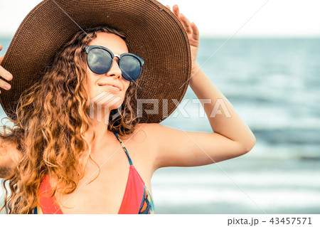 Happy young woman at beach in summer vacation. 43457571