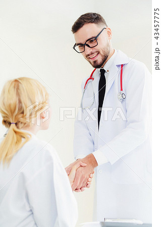 Doctor at hospital shakes hand with another doctor 43457775