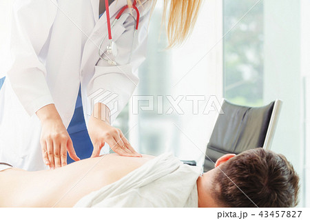 Woman Doctor and Male Patient in Hospital Office Woman Doctor and Male Patient in Hospital Office 43457827
