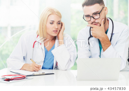 Two doctors partner works at office in hospital. Two doctors partner works at office in hospital. 43457830