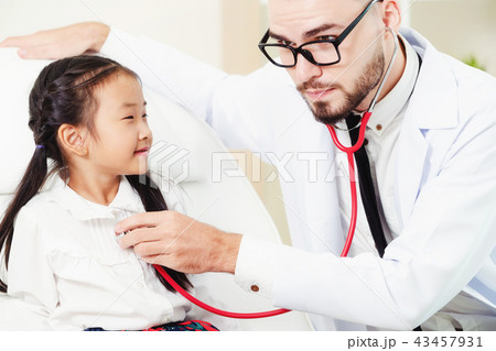 Doctor examining little happy kid in hospital. 43457931