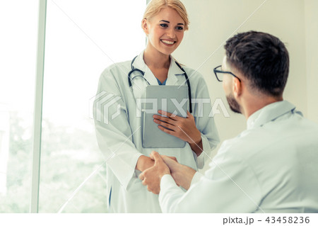 Doctor at hospital shakes hand with another doctor 43458236