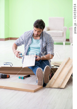 Man laying flooring at home 43459454