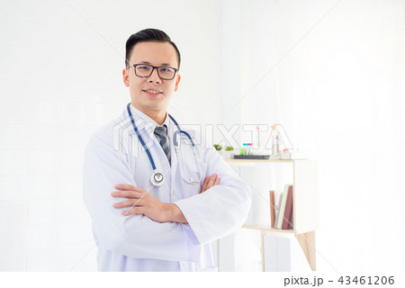 doctor standing in hospital office and smiles  43461206
