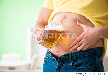 Fat obese man holding beer in dieting concept 43461451