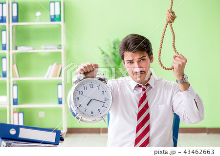 Despaired businessman thinking of suicide in the office Despaired businessman thinking of suicide in the office 43462663