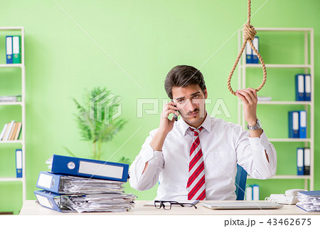 Despaired businessman thinking of suicide in the office Despaired businessman thinking of suicide in the office 43462675