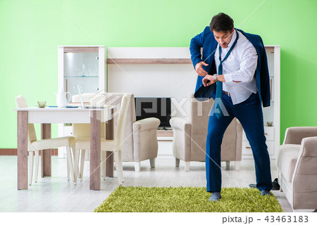 Man dressing up and late for work 43463183