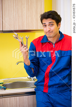 Plumber repairing tap at kitchen Plumber repairing tap at kitchen 43464676
