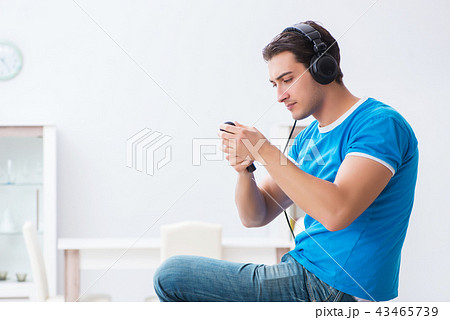 Young handsome man singing karaoke at home Young handsome man singing karaoke at home 43465739