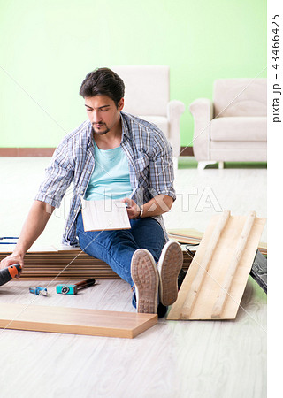 Man laying flooring at home Man laying flooring at home 43466425