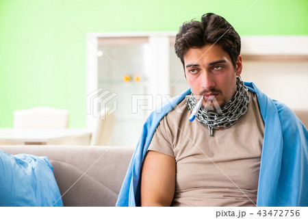 Sick young man suffering from flu at home Sick young man suffering from flu at home 43472756