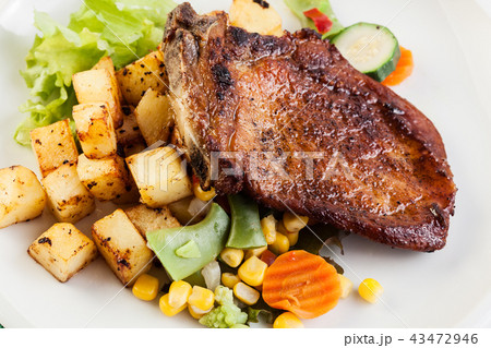 Fried pork with potatoes and vegetables salad 43472946