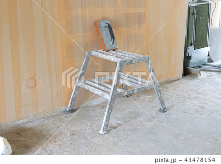 Small steps and a sponge used for plastering Small steps and a sponge used for plastering 43478154