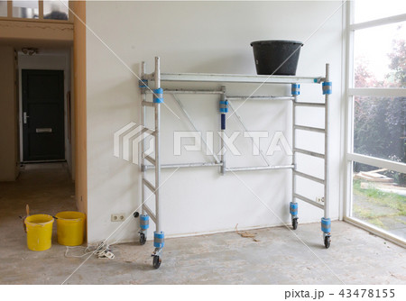Worker tools - Bucket standing on scaffolding Worker tools - Bucket standing on scaffolding 43478155