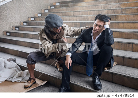 homeless man cheer up sad businessman 43479914
