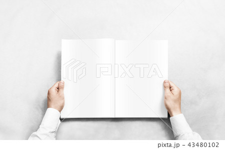 Hand opening white journal with blank pages mockup. Hand opening white journal with blank pages mockup. 43480102