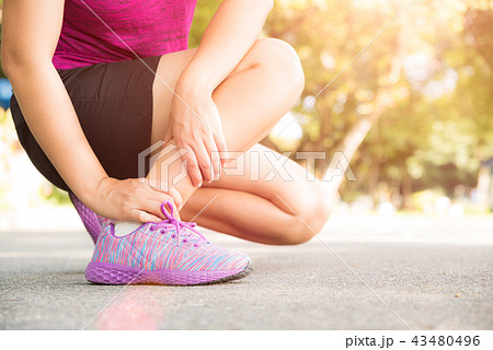 Woman suffering from an ankle injury Woman suffering from an ankle injury 43480496