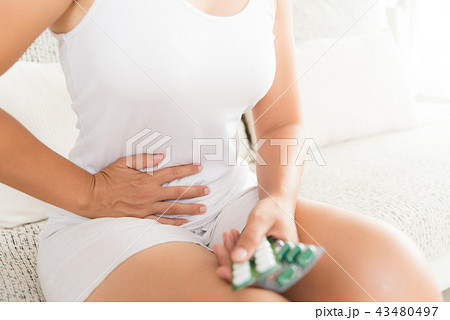 Young woman having painful stomachache Young woman having painful stomachache 43480497
