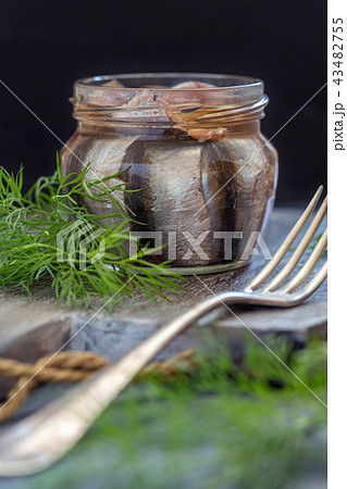 Glass jar with anchovies in olive oil. 43482755