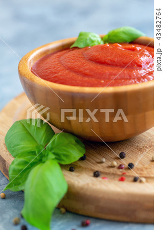 Wooden bowl with spicy tomato sauce. Wooden bowl with spicy tomato sauce. 43482764