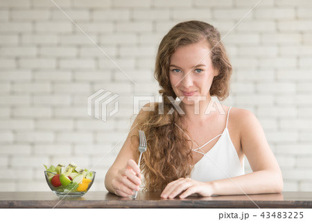 Young woman in joyful postures with salad bowl Young woman in joyful postures with salad bowl 43483225