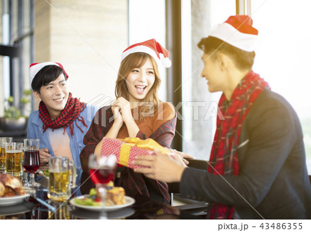 people celebrating and giving gift for christmas 43486355