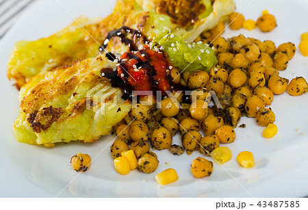Cabbage leaves in batter with garbanzos and sauce is tasty vegetarian dish Cabbage leaves in batter with garbanzos and sauce is tasty vegetarian dish 43487585