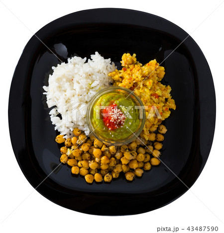 Dish of chickpeas and rice with red and green sauces 43487590