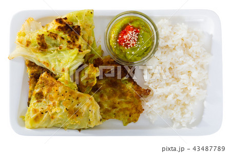 Top view of cabbage in batter with rice and sauces Top view of cabbage in batter with rice and sauces 43487789