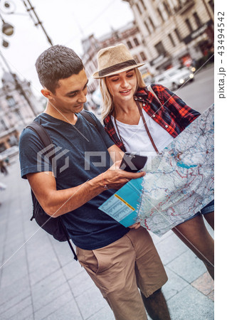 Couple exploring city location with map 43494542
