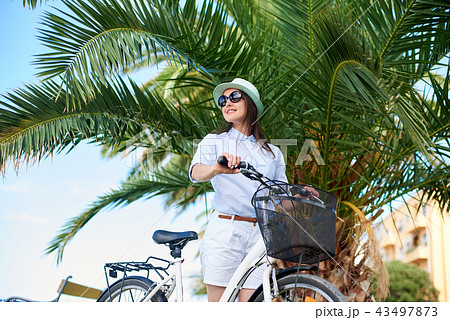 Young woman riding city bicycle near sea 43497873