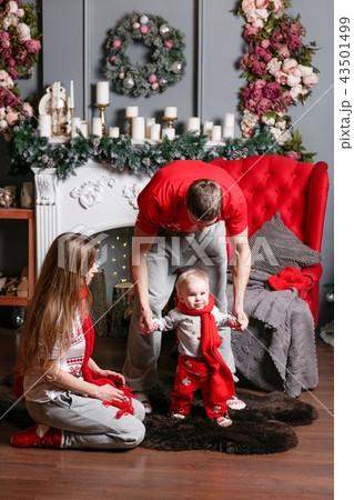 Loving family Merry Christmas and Happy New Year. Cheerful pretty people. Mom, dad and little baby Loving family Merry Christmas and Happy New Year. Cheerful pretty people. Mom, dad and little baby 43501499