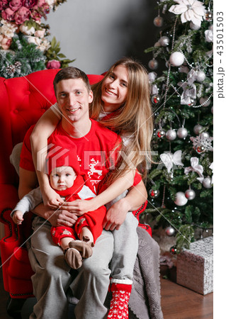 Loving family Merry Christmas and Happy New Year. Cheerful pretty people. Mom, dad and little baby 43501503